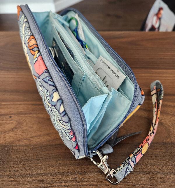 A wallet purse provides numerous slots for threads, buttons, needles, patch fabric, and more. (Myscha Theriault/TNS)