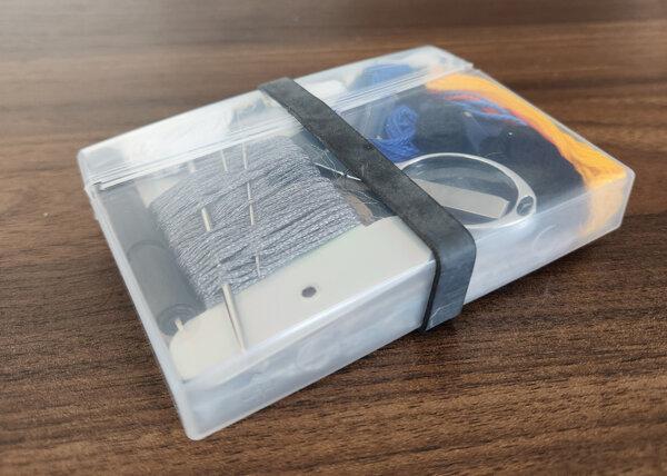 A clear chewing gum case serves as space-efficient sewing storage for a road trip. (Myscha Theriault/TNS)