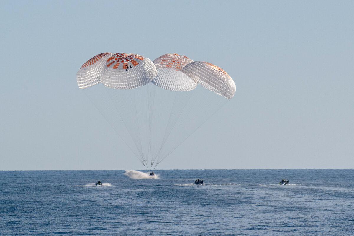 Support teams work around a SpaceX Dragon spacecraft shortly after it landed with NASA astronauts Nick Hague, Suni Williams, Butch Wilmore, and Roscosmos cosmonaut Aleksandr Gorbunov aboard in the water off the coast of Tallahassee, Fla., on March 18, 2025. (Keegan Barber/NASA via Getty Images)