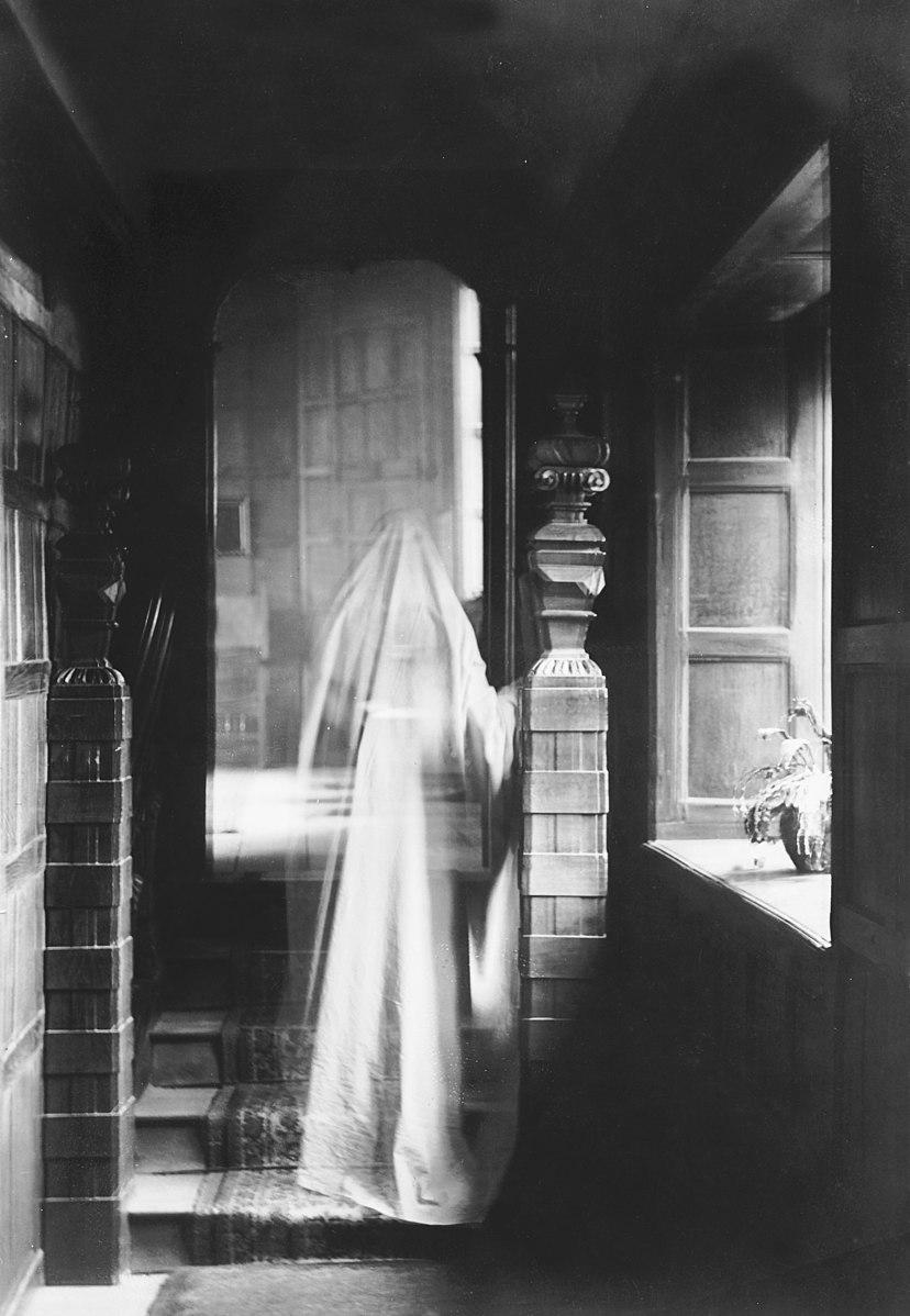 This 1899 photograph of a ghost was produced by double exposure. Ghosts don't scare the young man in the Brothers Grimm's story, but something else will. (Public Domain)