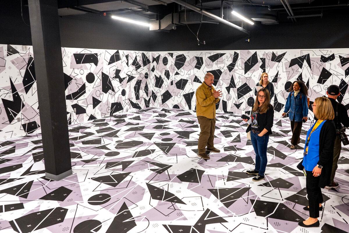 Paleontologist Ken Lacovara (left) leads a tour in the free-roam virtual reality room at the Edelman Fossil Park & Museum of Rowan University in Glassboro, New Jersey, during a media preview March 5, 2025, before the museum officially opens March 29. Lacovara is the founding executive director of the museum. The VR room is a "premium experience" journey that follows an expedition mission to collect scientific samples that comes face-to-face with dinosaurs. (Tom Gralish/The Philadelphia Inquirer/TNS)