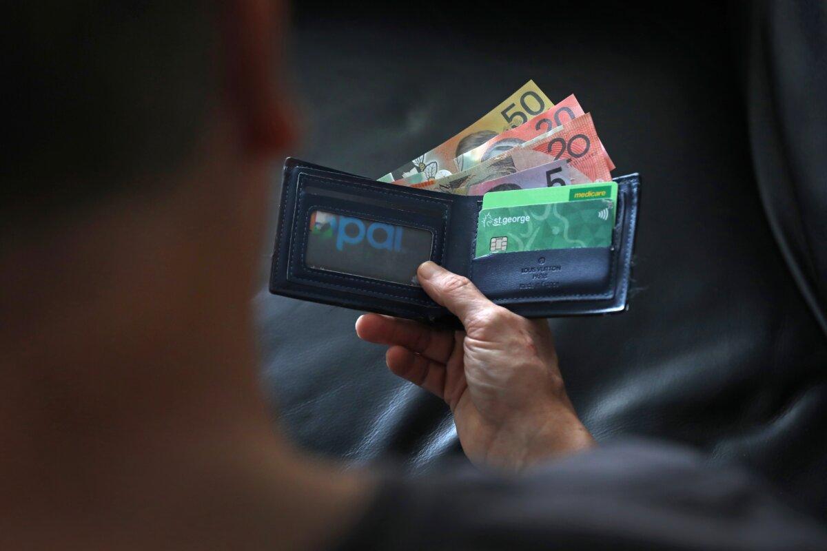 Australian $50, $20, $5, $5 bills and Australian Medicare Cards (Lisa Maree Williams/Getty Images) in a wallet in Sydney, Australia on March 25, 2025