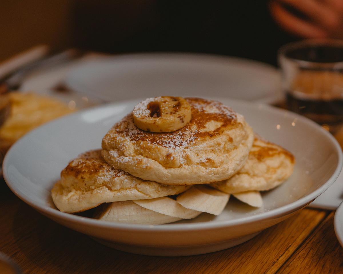 Ricotta hotcakes served with bananas and powdered sugar. (Bhuwan Bansal/Unsplash)