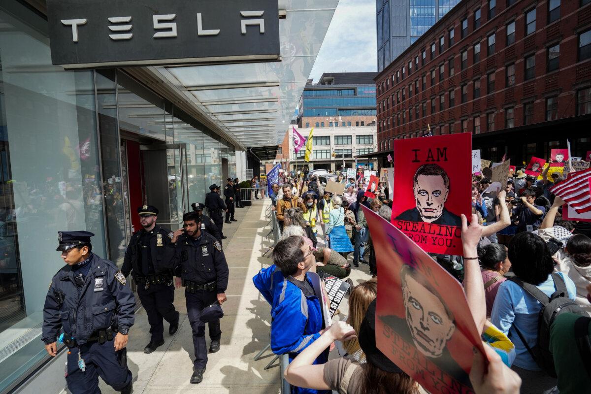 People take part in a protest against Tesla in New York City on March 29, 2025. (Samira Bouaou/The Epoch Times)