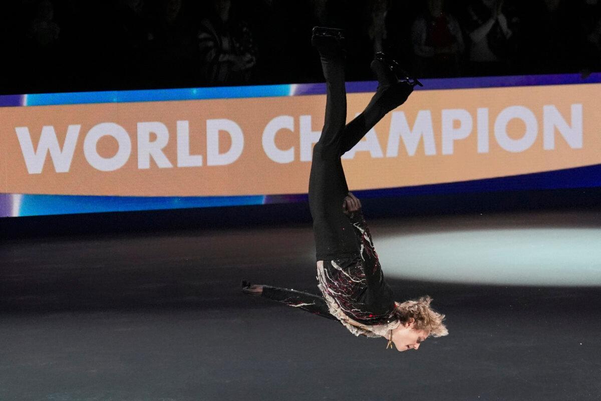 Ilia Malinin of the United States celebrates during a medal ceremony for men's free skating at the figure skating world championships in Boston on March 29, 2025. (Charles Krupa/AP Photo)