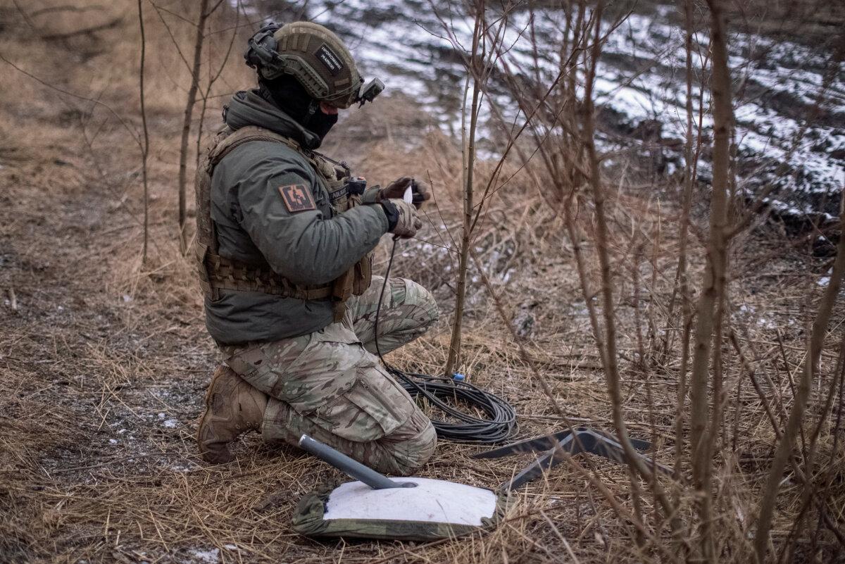 A Ukrainian serviceman of the 47th brigade prepares a Starlink satellite system amid Russia's attack on Ukraine, near the town of Avdiivka, Ukraine, on Feb. 20, 2024. (Inna Varenytsia/Reuters)