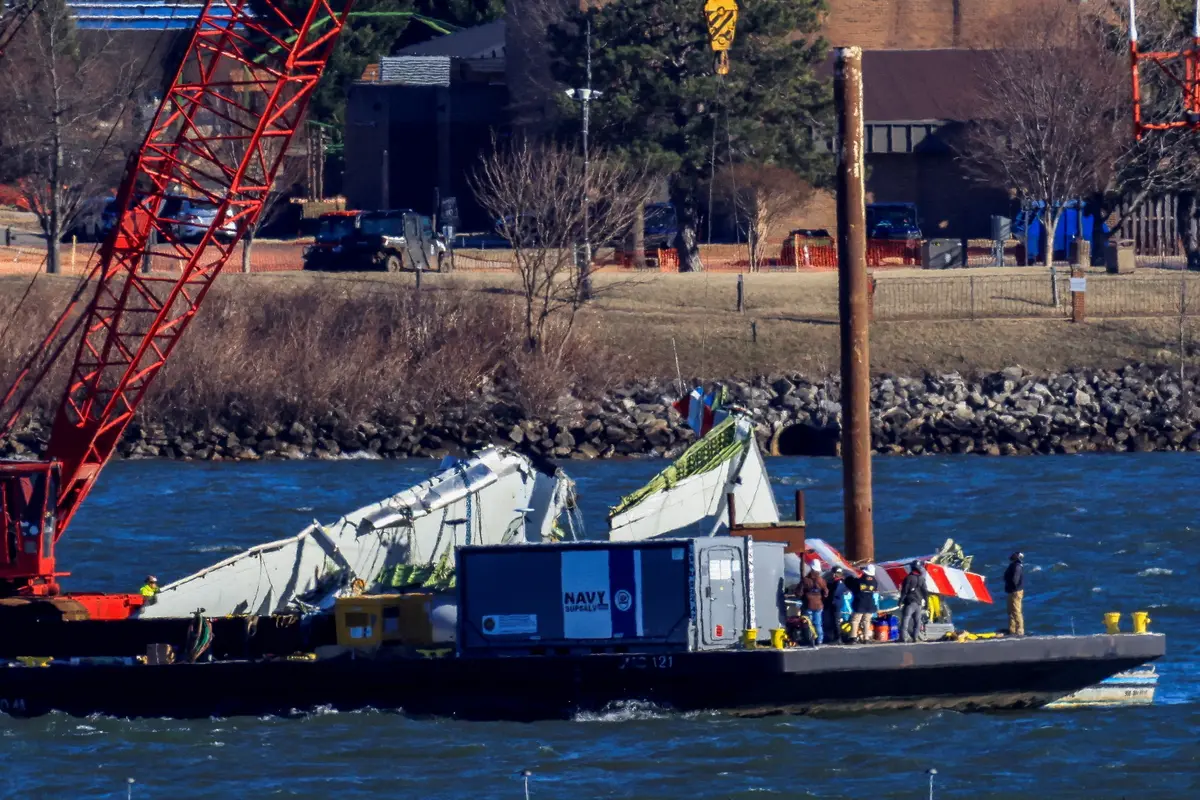 A crane retrieves part of the wreckage from the Potomac River, in the aftermath of the collision of American Eagle flight 5342 and a Black Hawk helicopter that crashed into the river, by the Ronald Reagan Washington National Airport, in Arlington, Va., on Feb., 4, 2025. (Eduardo Munoz/Reuters)