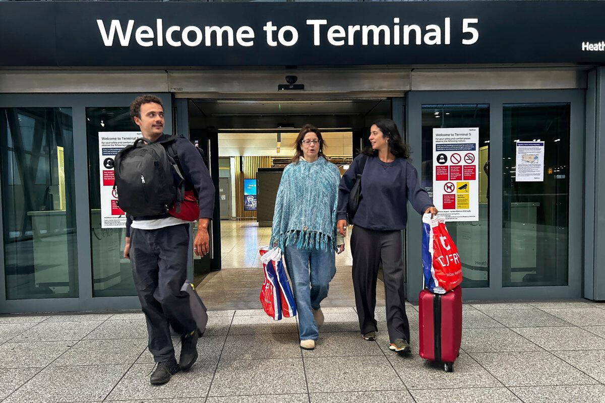Travelers arrive at Terminal 5 as Heathrow Airport slowly resumes flights after a fire cut power to Europe's busiest airport in London on March 22, 2025. (Kirsty Wigglesworth/AP)