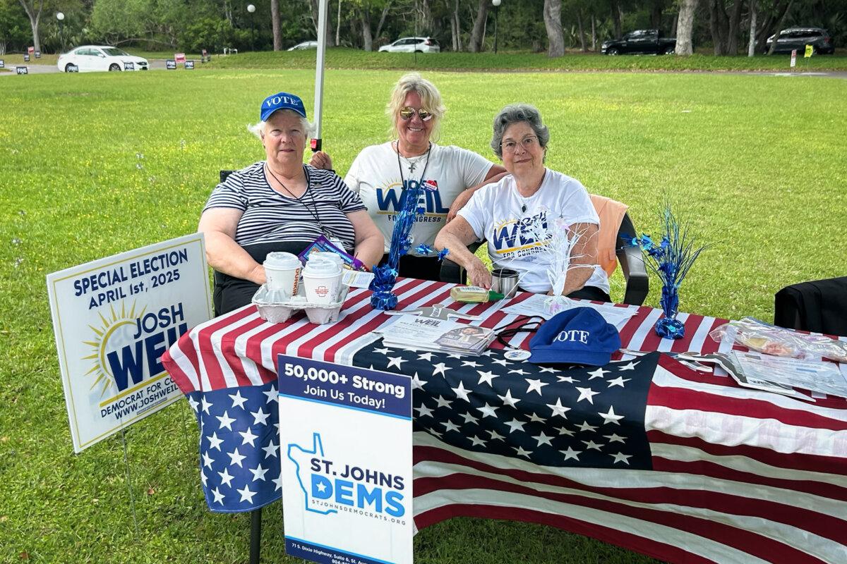(LâR) Claire Southerland, Barbara Bay, and Deborah Pavelle man a table for Democratic congressional candidate Josh Weil in St. Augustine, Fla., on April 1, 2025. (Samantha Flom/The Epoch Times)