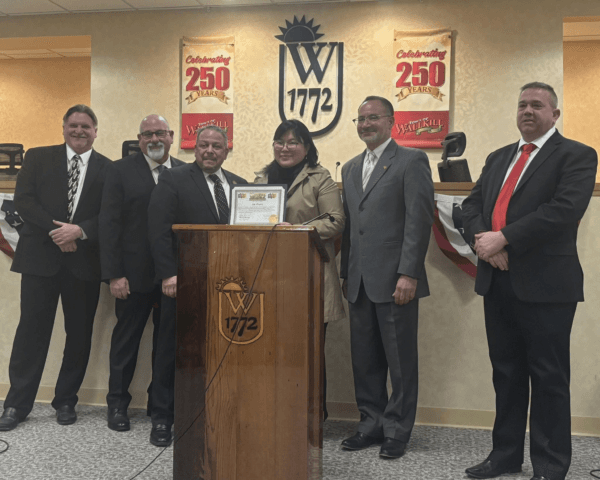 (L–R) Town of Wallkill Councilmen Eric Johnson and Steven Vinella, Supervisor George Serrano, Pang Jin, and Councilmen Eric Valentin and Mark Coyne at a town board meeting in Middletown, N.Y., on March 27, 2025. (Courtesy of Pang Jin)