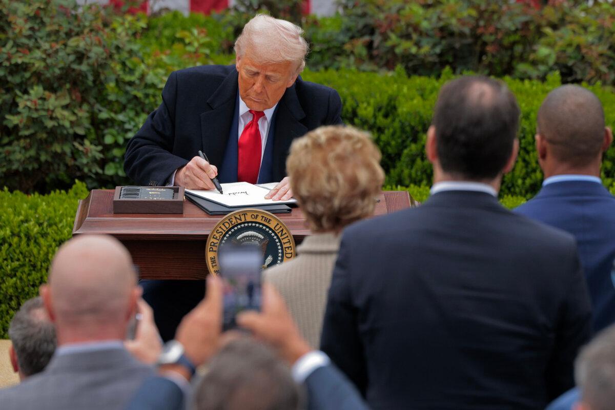 President Donald Trump signs executive orders raising tariffs on products made in foreign countries during a “Make America Wealthy Again” event in the Rose Garden at the White House on April 2, 2025. (Chip Somodevilla/Getty Images)