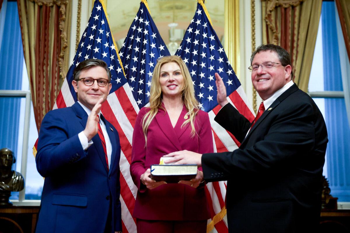 House Speaker Mike Johnson (R-La.) (L) participates in a ceremonial swearing-in with Rep. Randy Fine and his wife Wendy Fine at the Capitol on April 2, 2025. (Kayla Bartkowski/Getty Images)