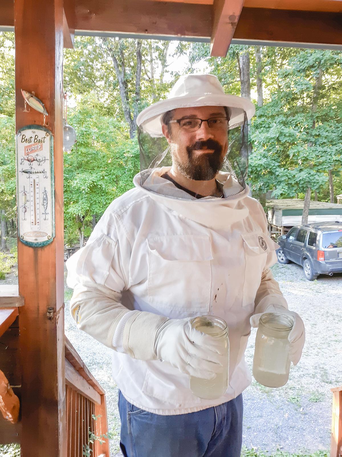 Educator Chris Hall feeds sugar syrup to honeybees on his Virginia homestead. (Courtesy of Chris Hall)
