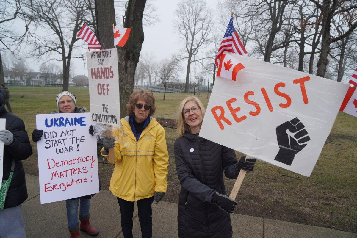 Three members of the "resistance" at the "Mobilization Day" rally in Port Huron, Mich. on April 5, 2025. (Steven Kovac/Epoch Times)