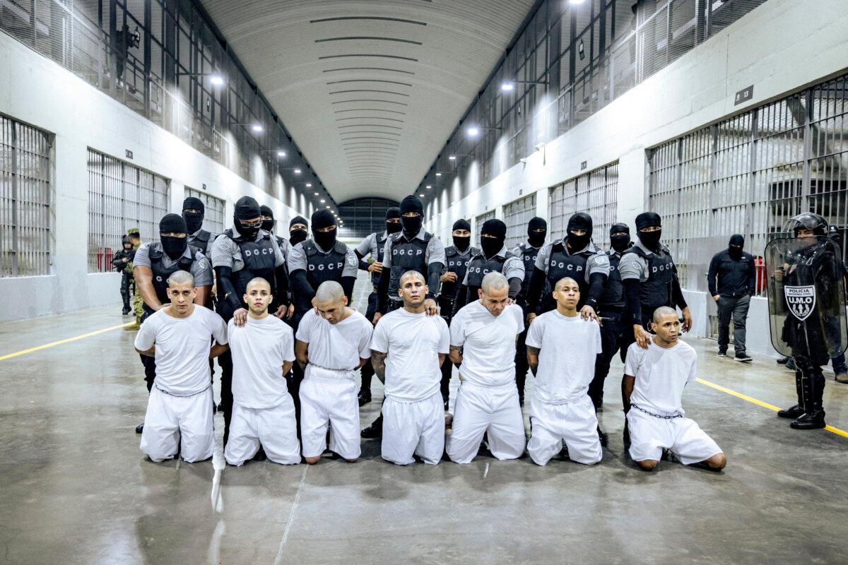 Salvadoran guards escort alleged members of the Tren de Aragua and MS-13 gangs recently deported by the U.S. government to be imprisoned in the Terrorism Confinement Center in Tecoluca, El Salvador, on March 31, 2025. (President's press secretary/Handout via Reuters)