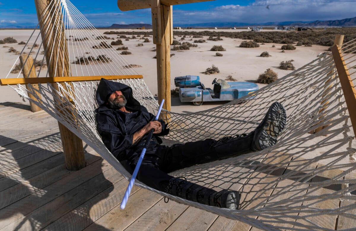 Robert P. Truex takes a rest on a hammock at the playa at OutpostX. (L.E. Baskow/Las Vegas Review-Journal/TNS)