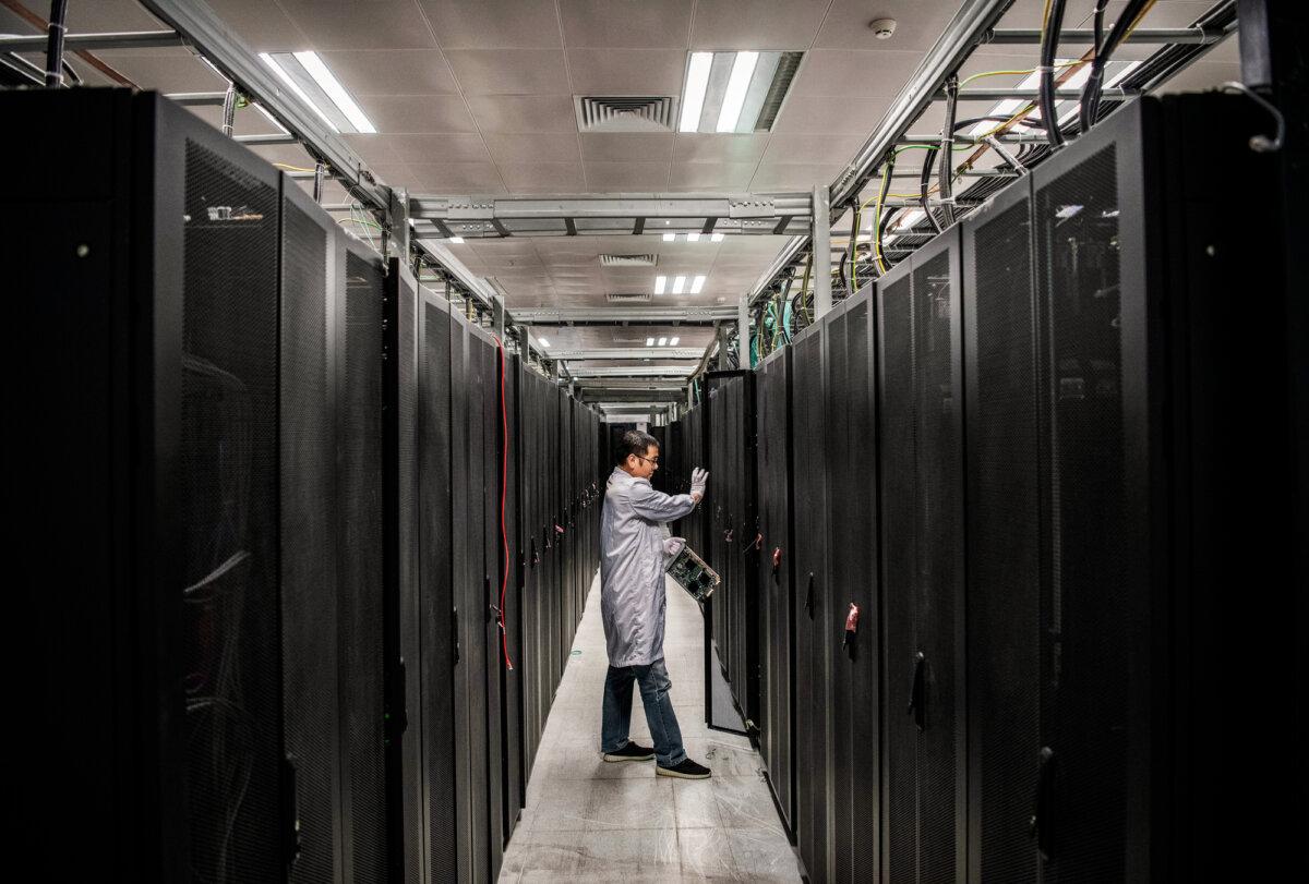An engineer opens the door of a server unit during an organized tour at the Cyber Security Lab of Huawei in Dongguan, Guangdong Province, China, on April 25, 2019. Because the Chinese Communist Party law mandates that information is a national resource, Americans’ most personal data transferred to a server in China effectively sends the data directly to the regime. (Kevin Frayer/Getty Images)