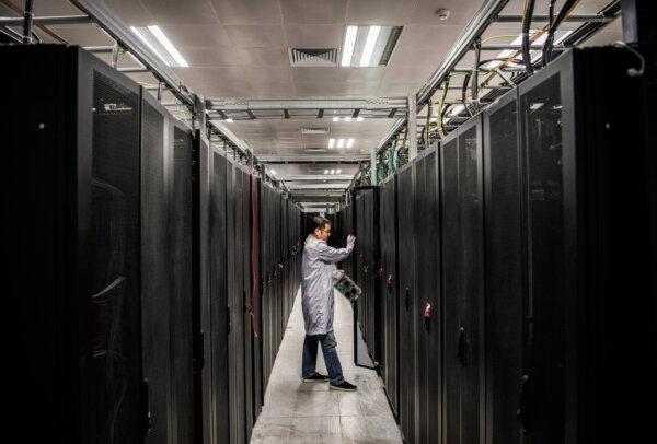 An engineer opens the door of a server unit during an organized tour of Huawei's cybersecurity lab in Dongguan, Guangdong Province, China, on April 25, 2019. (Kevin Frayer/Getty Images)