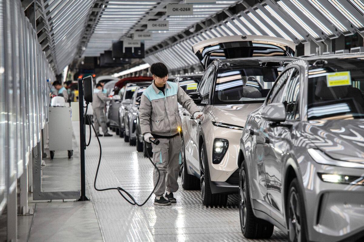 A worker inspects a vehicle’s charging system in Hefei, China, on Jan. 17, 2025. (Kevin Frayer/Getty Images)