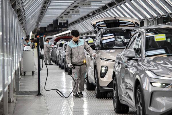 A worker inspects a vehicle's charging system in Hefei, China, on Jan. 17, 2025. (Kevin Frayer/Getty Images)