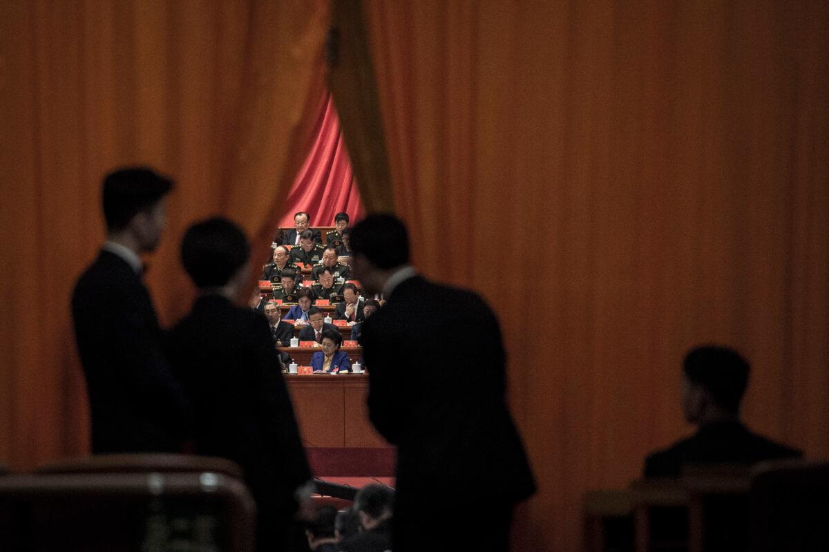 Chinese security guards look at military delegates during the speech of Chinese leader Xi Jinping at the Communist Party's 19th Congress in Beijing on Oct. 18, 2017. (Fred Dufour/AFP via Getty Images)