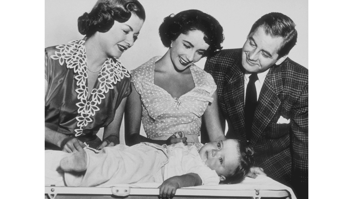 Ellie Banks (Joan Bennett), Kay Dunstan (Elizabeth Taylor), and Buckley Dunstan (Don Taylor) admire the new baby, in “Father’s Little Dividend.” (Metro-Goldwyn-Mayer)