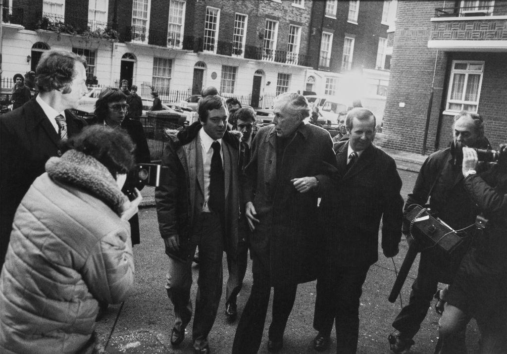 British art historian Anthony Blunt (C) is besieged by photographers after being exposed as a Soviet spy in November 1979. (Daily Express/Archive Photos/Getty Images)