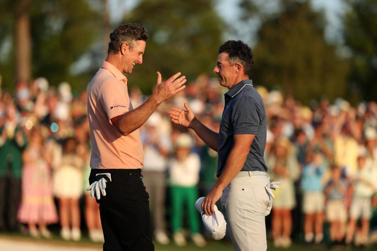 Rory McIlroy (R) of Northern Ireland shakes hands with Justin Rose of England after the playoff hole during the final round of the 2025 Masters Tournament at Augusta National Golf Club in Augusta, Georgia, on April 13, 2025. (Richard Heathcote/Getty Images)