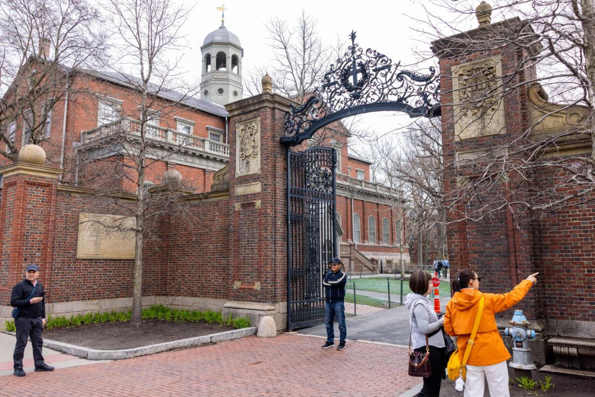 Tourists in front of the main gate to Harvard Yard in Cambridge, Mass., on April 15, 2025. (Scott Eisen/Getty Images)