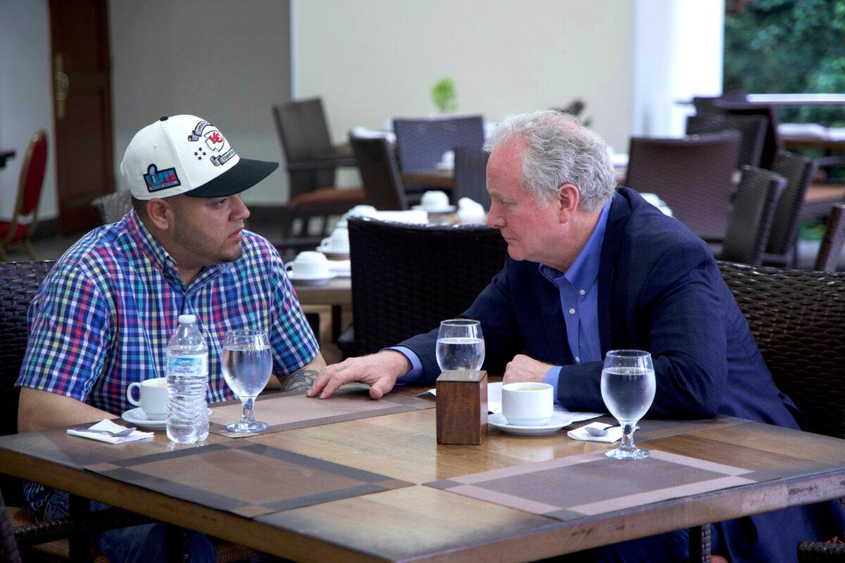 Sen. Chris Van Hollen (D-Md.) speaks with Kilmar Abrego Garcia (L) in a hotel restaurant in San Salvador, El Salvador, on April 17, 2025. (Press Office Senator Van Hollen via AP)