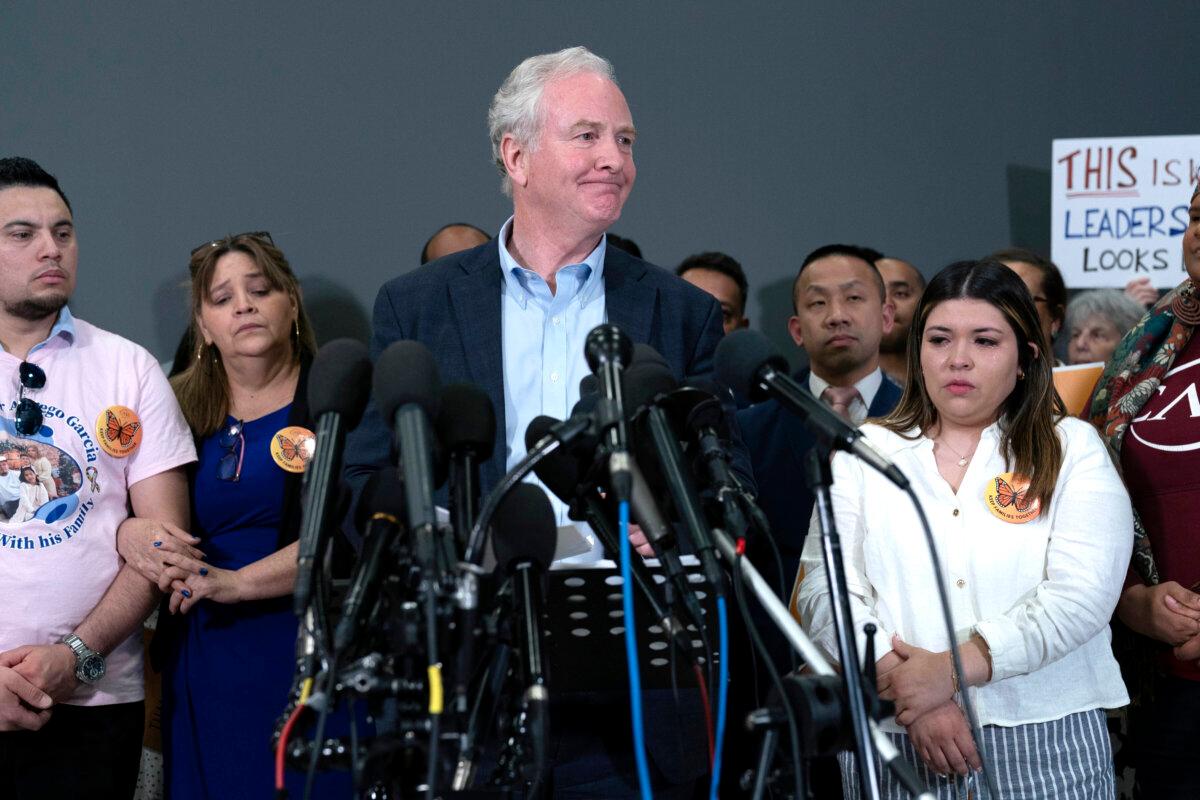 Sen. Chris Van Hollen (D-Md.) (C), accompanied by Cesar Abrego Garcia, from left, Cecilia Garcia and Jennifer Vasquez Sura, speaks during a news conference upon his arrival from meeting with Kilmar Abrego Garcia in El Salvador, at Washington Dulles International Airport, in Chantilly, Va., on April 18, 2025. (Jose Luis Magana/AP Photo)