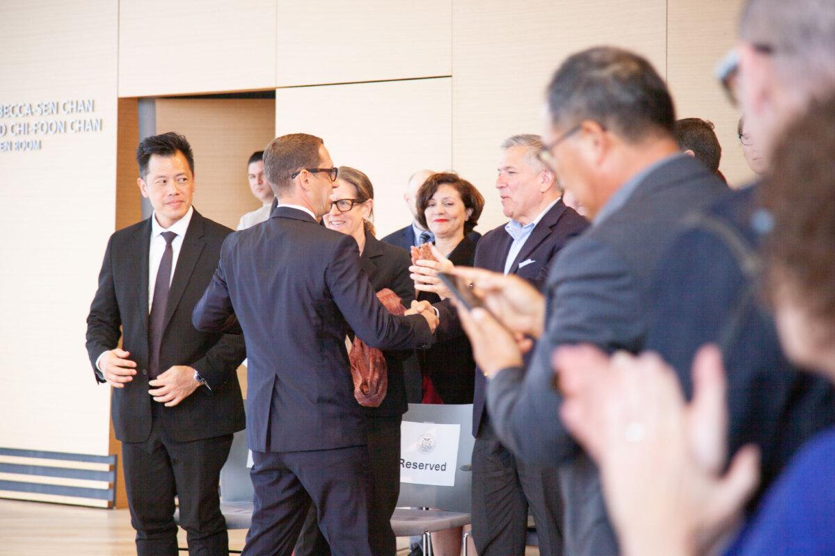 San Francisco Mayor Daniel Lurie shakes hands with Supervisor Matt Dorsey after his speech on the eve of his 100 days in office on April 17, 2025. (Lear Zhou/The Epoch Times)
