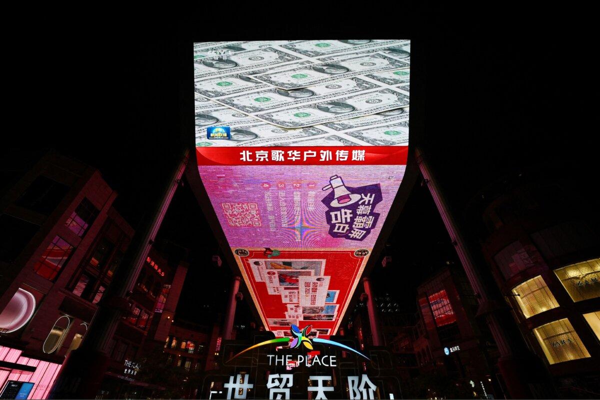News coverage is shown on a large screen outside a shopping mall during coverage of U.S. tariffs, in Beijing on April 11, 2025. (Greg Baker/AFP via Getty Images)