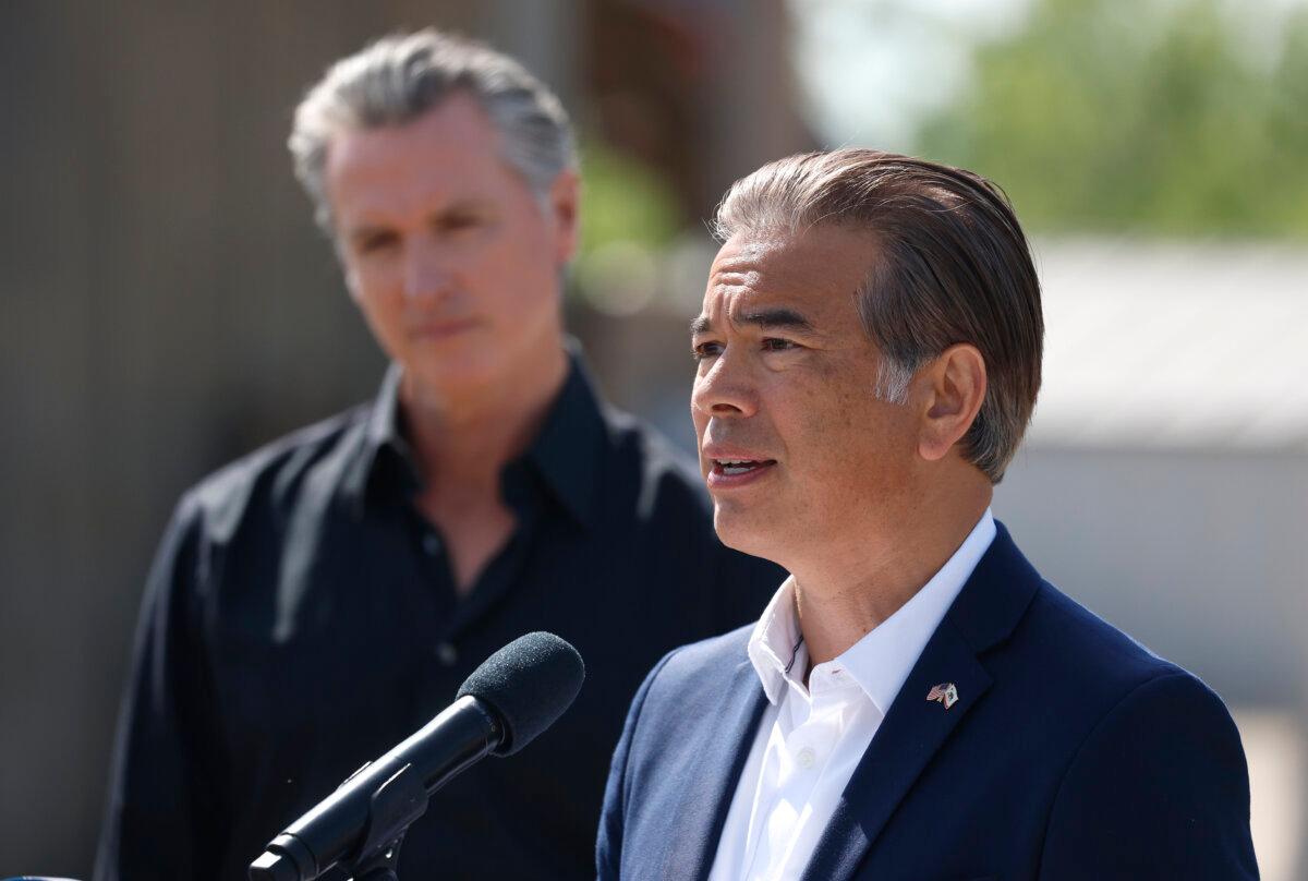 California Attorney General Rob Bonta speaks as Gov. Gavin Newsom looks on during a news conference at Gemperle Orchards in Ceres, Calif., on April 16, 2025. (Justin Sullivan/Getty Images)