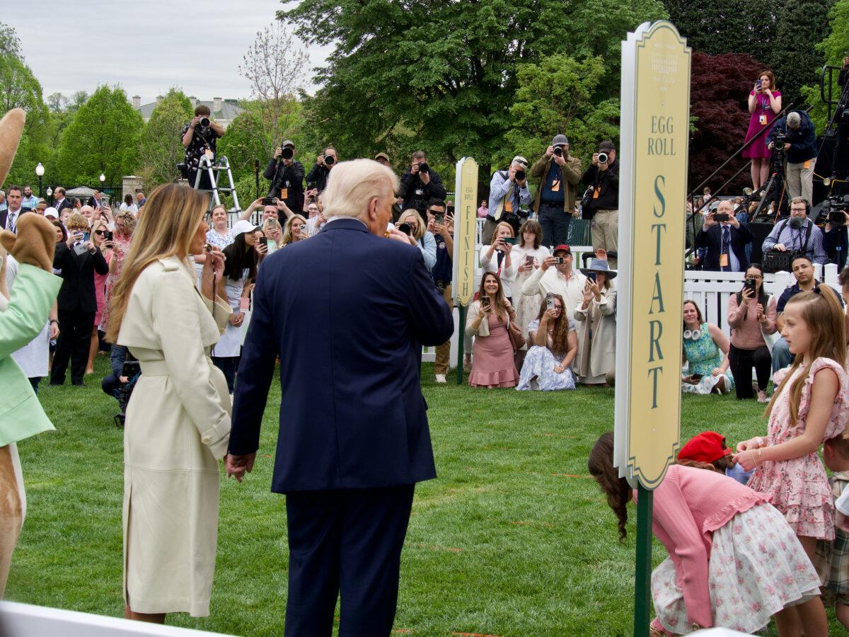 First Lady Melania Trump and President Donald Trump blow the whistle to start an egg roll race on the South Lawn of the White House on April 21, 2025. (Travis Gillmore/The Epoch Times)