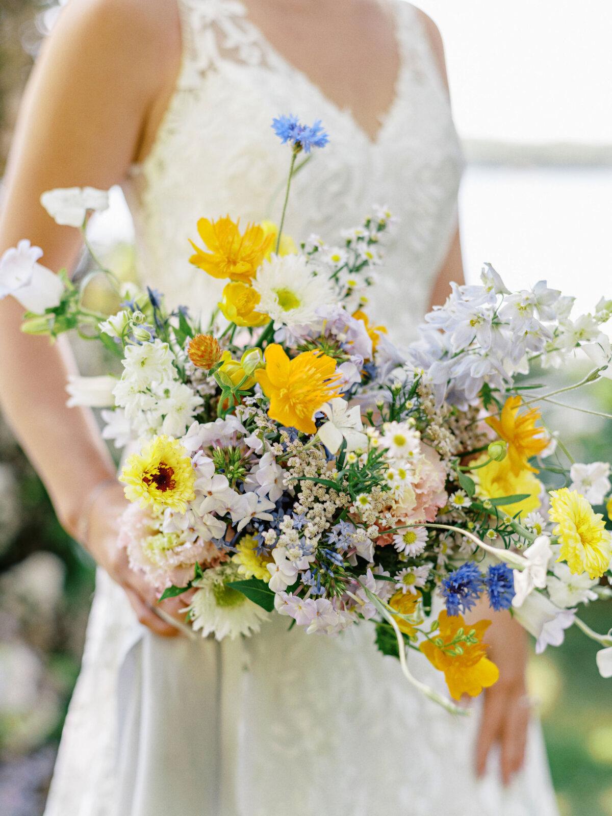 A summer wildflower-inspired bouquet of yarrow, bachelor’s buttons, feverfew, argostemma, campanula, aster, and delphinium, for a July wedding. (Ryan Ray Photography)