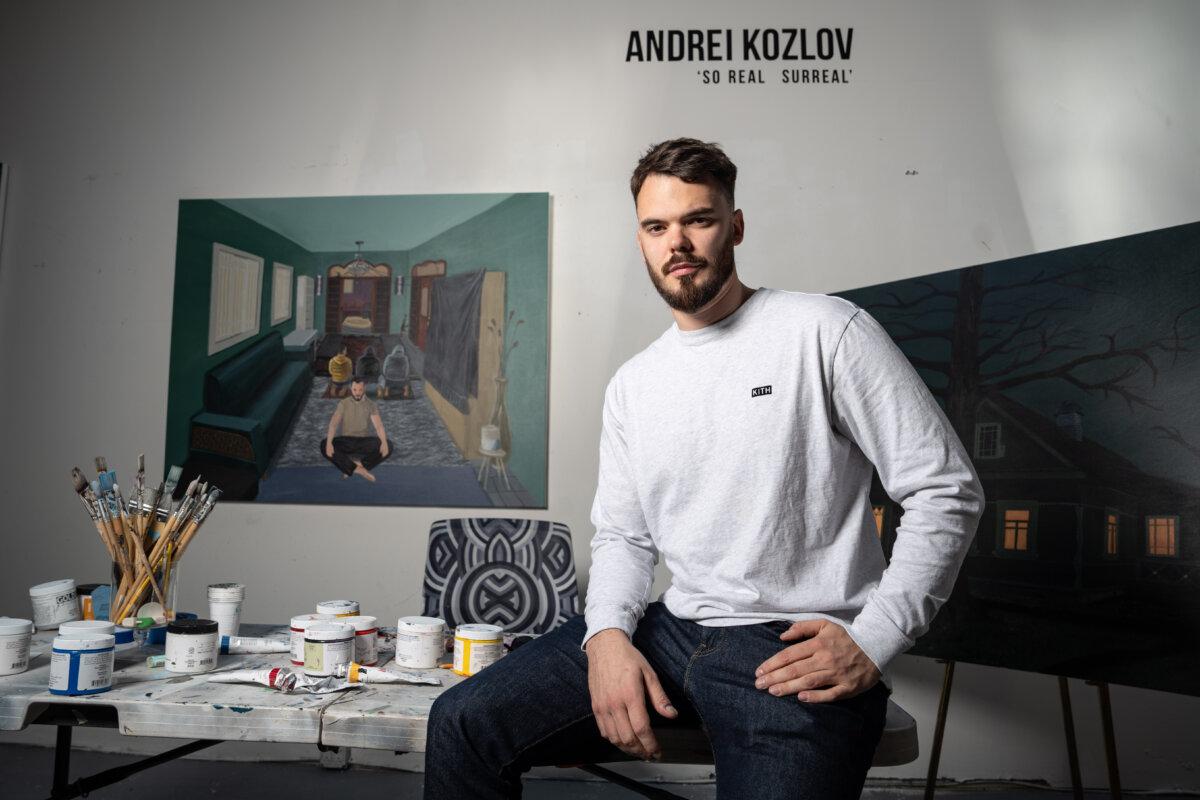Andrei Kozlov poses with some of his artwork at a studio in New York City on April 24, 2025. (Samira Bouaou/The Epoch Times)