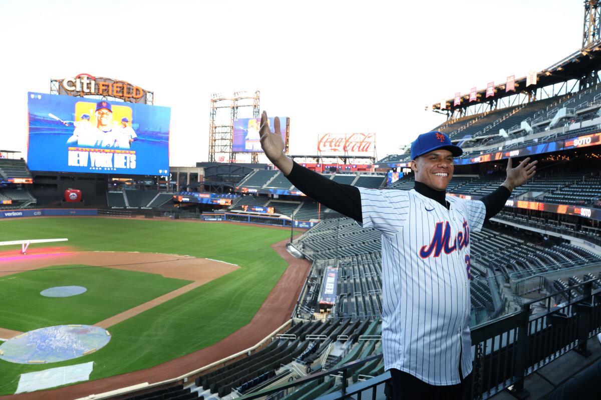 Juan Soto of the New York Mets poses with his new uniform after his introductory press conference at Citi Field in New York City on Dec. 12, 2024 . (Al Bello/Getty Images)
