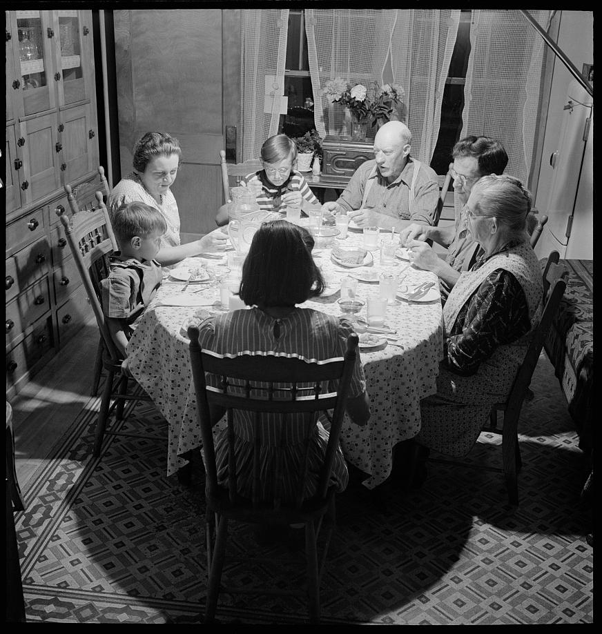 A Vermont family enjoy dinner together in East Montpelier, 1942. Library of Congress. (Public Domain)