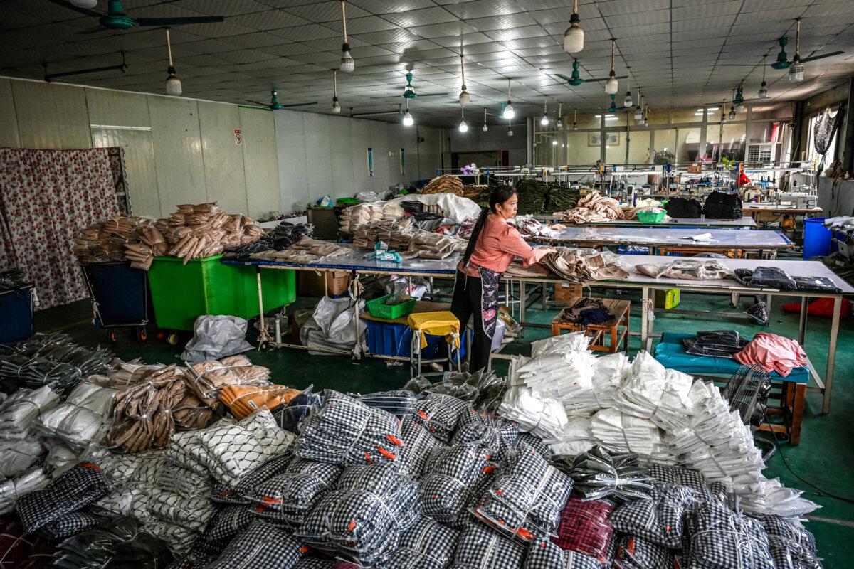 An employee packages garments for the online Chinese e-commerce company Temu at a clothing factory in Guangzhou, in southern China's Guangdong Province, on April 16, 2025. (Jade Gapo/AFP via Getty Images)