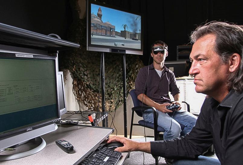 Dr. Rizzo gets the simulator ready for a veteran preparing for a VR immersion demo. (Courtesy of Skip Rizzo)
