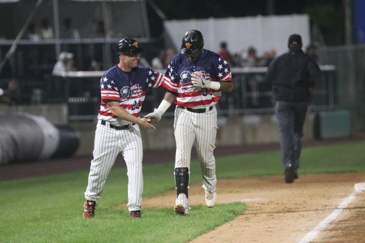 Long Island Ducks’ manager Lew Ford congratulates Mark Washington, who has reached as high as Triple-A ball in MLB-affiliated leagues. (Courtesy of Long Island Ducks)