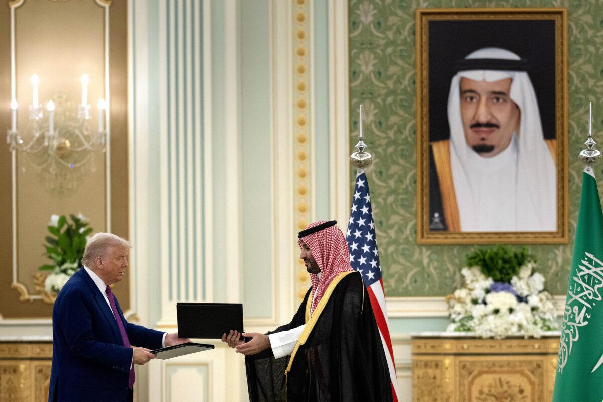U.S. President Donald Trump and Saudi Crown Prince Mohammed bin Salman exchange folders after signing an agreement during a bilateral meeting in Riyadh on May 13, 2025. (Brendan Smialowski/AFP via Getty Images)