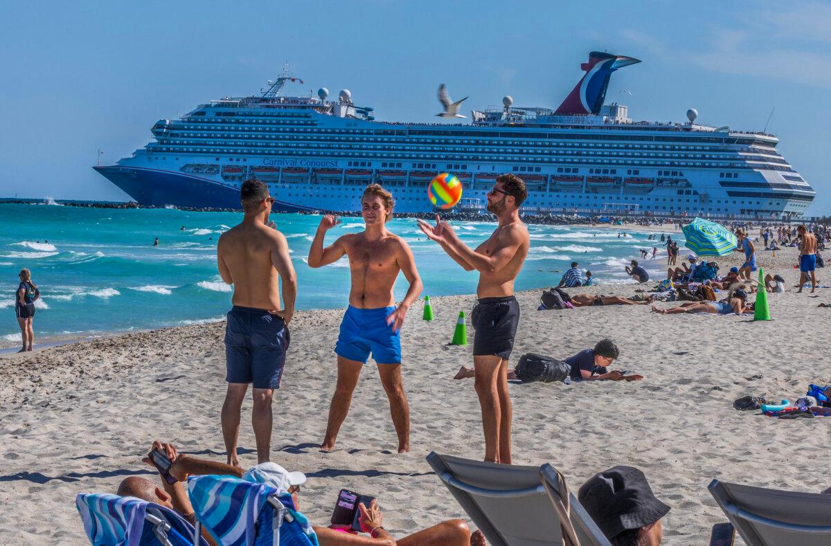 The Carnival Conquest cruise ship departs from PortMiami through the Government Cut channel as beachgoers enjoy the nice weather in South Beach, during the spring break, in Miami Beach, Florida, on March 21, 2025. (Pedro Portal/Miami Herald/TNS)