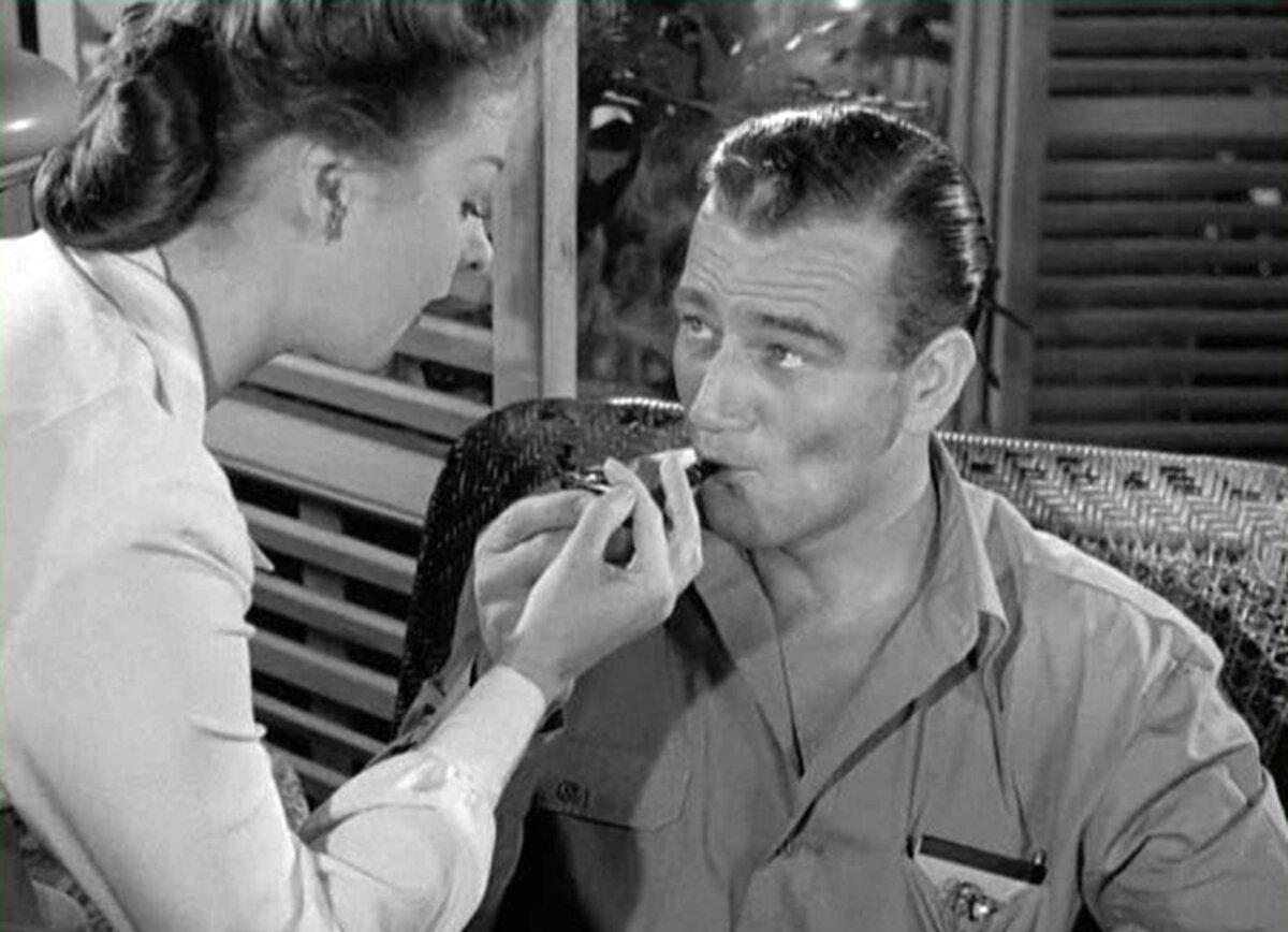 Constance “Connie” Chesley (Susan Hayward) being actively pursued by Wedge Donovan (John Wayne), in “The Fighting Seabees.” (Republic Pictures)
