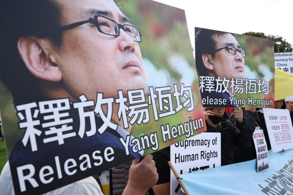 The protesters hold a placard requesting the release of Australian author Jan Henjun in Canberra, Australia on March 20, 2024 (David Gray/AFP via Getty Images)