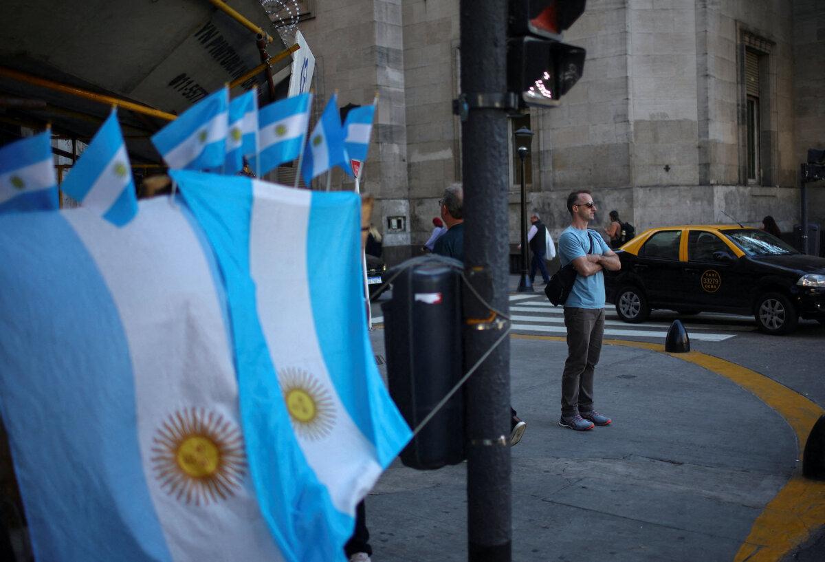 A man stands next to a street store selling Argentinian flags in downtown Buenos Aires, Argentina, on April 14, 2025. (Agustin Marcarian/Reuters)