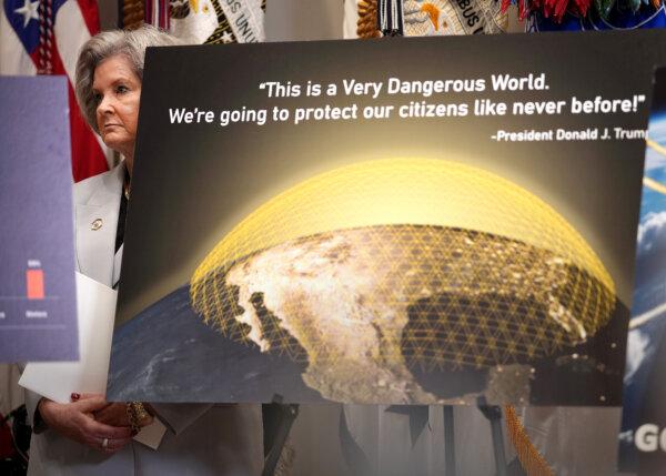 White House staff chief Susie Wills is looking at the back of the Golden Dome missile defense system charts when President Donald Trump speaks at a press conference held at the White House's Roosevelt Room on May 12, 2025.