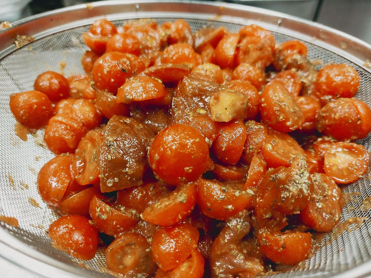 Halve the cherry tomatoes, sprinkle them with salt, and let them sit. Then, season them with oregano. (Kevin Revolinski)