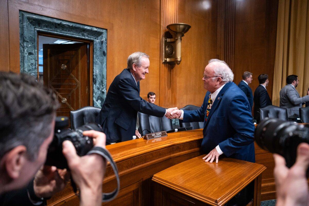 IRS commissioner nominee Billy Long shakes hands with Chairman of the Senate Committee on Finance Mike Crapo (R-Idaho) ahead of his confirmation hearing on Capitol Hill in Washington on May 20, 2025. (Madalina Vasiliu/The Epoch Times)